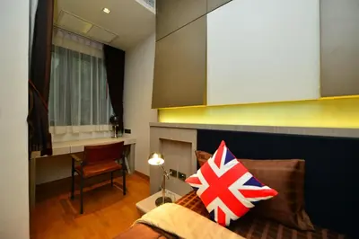 a bedroom with a bed with a pillow with a flag at Bukit Pool Villas - SHA Extra Plus in Patong Beach