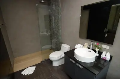 a bathroom with a toilet and a sink and a shower at Pumeria Resort Phuket - SHA Plus in Bang Tao Beach