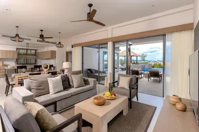 a living room with a couch and a table at CASABAY Luxury Pool Villas by STAY in Rawai Beach