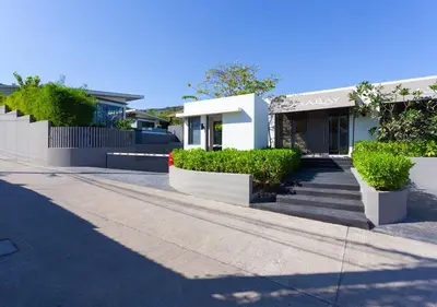 a white building with stairs in front of it at CASABAY Luxury Pool Villas by STAY in Rawai Beach