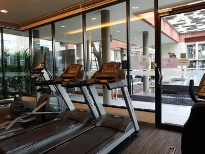 a gym with three treadmills in front of a window at Dcondo Kathu Patong Phuket by Jack in Kathu
