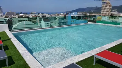 a swimming pool on the roof of a building at Neon Patong in Patong Beach