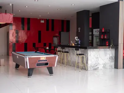 a pool table in a room with a bar at Neon Patong in Patong Beach