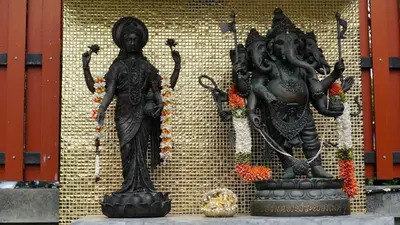 two statues on a wall next to a wall at Maneetel Krabi Beachfront-SHA Plus in Ao Nang Beach