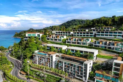 an aerial view of buildings with the ocean at Wyndham Grand Phuket Kalim Bay in Patong Beach