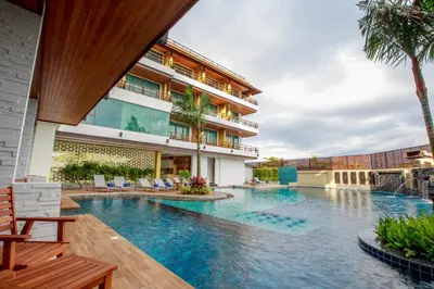 a swimming pool in front of a building at Aqua Resort Phuket - Near Beach and Chalong Pier in Rawai Beach