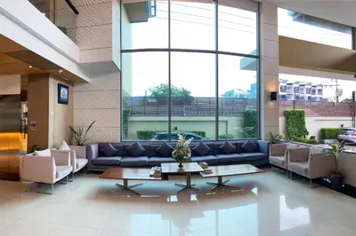 a lobby with a couch and a table in a building at Aqua Resort Phuket - Near Beach and Chalong Pier in Rawai Beach