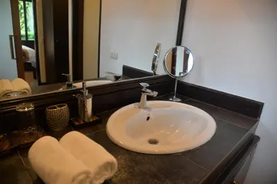 a bathroom with a sink and a mirror at Tukonnee Villas Koh Yao Noi in Ko Yao Noi