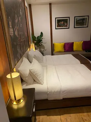 a bedroom with a bed with white sheets and pillows at Tukonnee Villas Koh Yao Noi in Ko Yao Noi