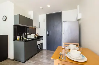 a kitchen with a table with plates on it at The Deck Condominium Patong Beach in Patong Beach