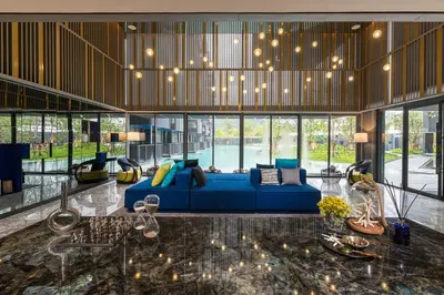 a living room with a blue couch in a building at The Deck Condominium Patong Beach in Patong Beach