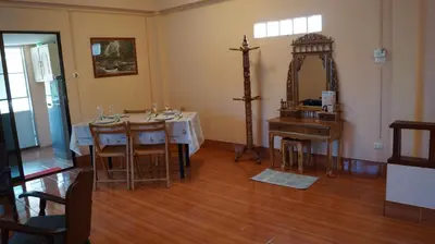 a dining room with a table and a mirror at Kata Apartment in Kata Beach