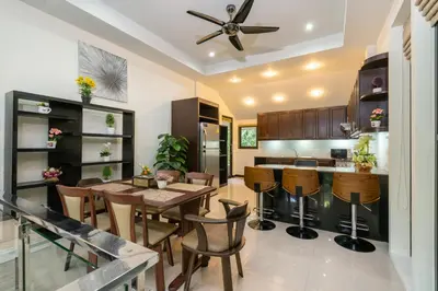 a kitchen and dining room with a table and chairs at Boutique Resort Private Pool Villa - SHA Extra Plus in Thalang