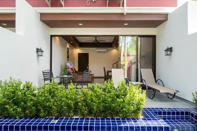 a patio with chairs and a table and some plants at Boutique Resort Private Pool Villa - SHA Extra Plus in Thalang