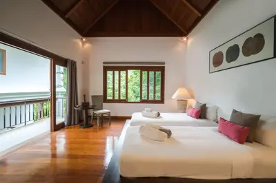 a bedroom with two beds and a large window at Vichuda Hills by RESAVA in Layan Beach