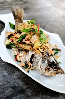 a plate of food with a seafood dish on a table at Phi Phi Phu Chalet Resort in Phi Phi Don