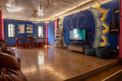 a living room with a tv and a blue wall at K-Bunk AoNang Center in Ao Nang Beach