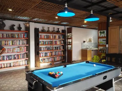 a billiard room with a pool table and books at The Luna in Nai Yang Beach