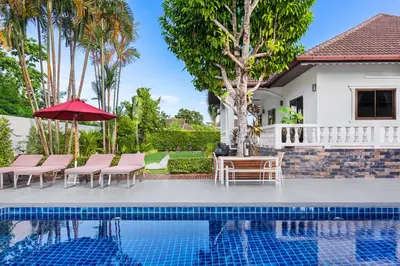 a villa with a swimming pool and a house at Happy Family Villa 2 in Chalong