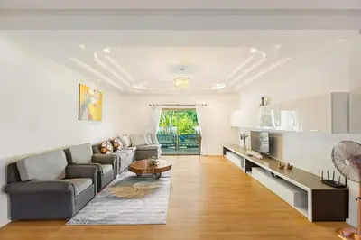 a living room with a couch and a table at Happy Family Villa 2 in Chalong