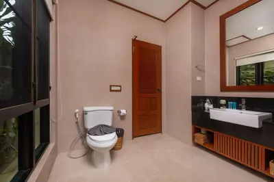 a bathroom with a toilet and a sink at Villa Raas 3BR Private PoolNaiharn beach in Nai Harn Beach