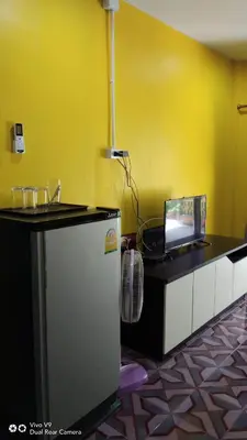 a kitchen with a counter with a laptop on it at Baan Asree homestayบ้านอัสรี in Ao Nang Beach