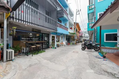 an empty street with a motorcycle parked in the middle at Hip Hostel - SHA Plus in Patong Beach