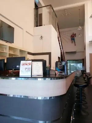 a bar in a building with a volley ball at Buk Inn Hotel SHA Plus in Kamala Beach