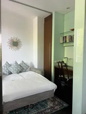 a bedroom with a bed with a mirror and a desk at Kata Gardens Apartments in Kata Beach