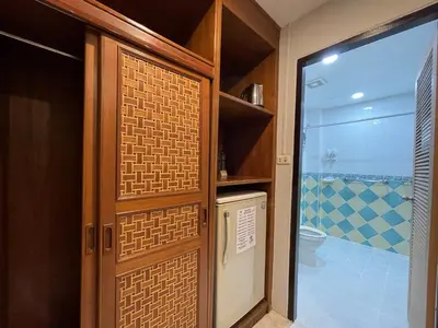a bathroom with a shower and a door with a toilet at Summer Breeze Hotel in Patong Beach