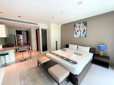 a large bedroom with a large bed and a desk at Emerald Terrace Apartments by Lofty in Patong Beach
