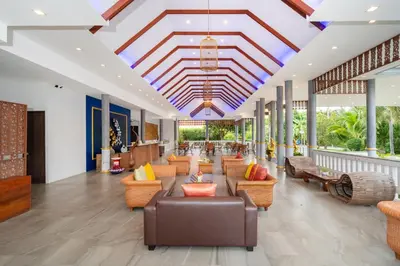 a lobby of a resort with couches and chairs at Phuket La Siesta in Nai Harn Beach
