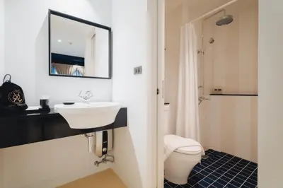 a bathroom with a sink and a toilet at Xinlor House - Phuket Old Town in Phuket Town