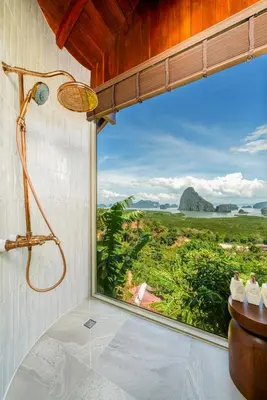 a bathroom with a shower and a large window at Sametnangshe Boutique in Phangnga