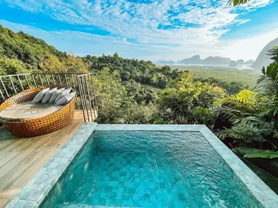 a pool with a bench and a view of the mountains at Sametnangshe Boutique in Phangnga
