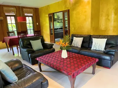 a living room with leather couches and a coffee table at Symphony Villa in Nai Harn Beach