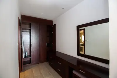 a bathroom with a large mirror and a dresser at Baan Phukhao in Klong Muang Beach