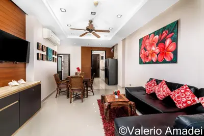 a living room with a couch and a table at Sea & Sky Karon Beach by PHR in Karon Beach