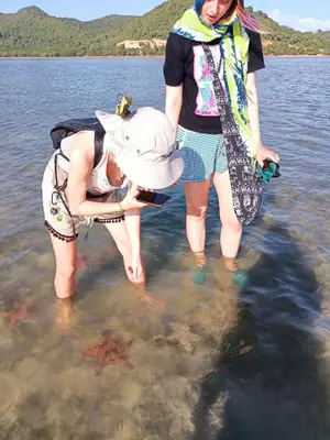two women are standing in the water at Activities Resort in Ko Yao Yai