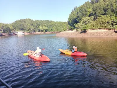 two people in red and yellow kayaks on a river at Activities Resort in Ko Yao Yai