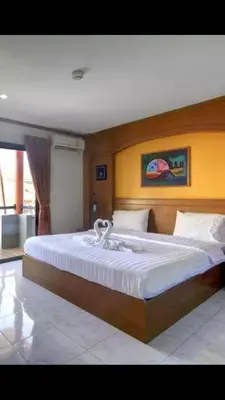 a bedroom with a large bed in a room at Baantonkhaokata Hotel in Kata Beach