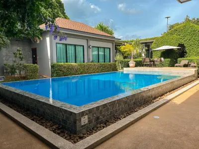 a swimming pool with a water feature in a yard at BaanMee Phuket near Chalong Pier in Chalong