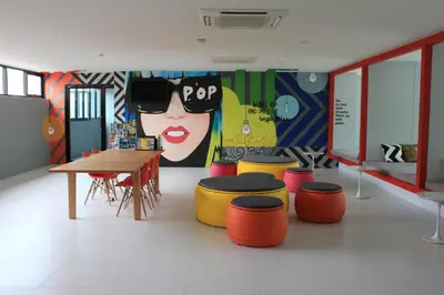 a room with a table and stools and a mural at Wake Up Aonang Hotel in Ao Nang Beach