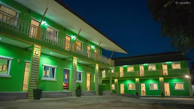 a building with green lights on it at night at Vii House Rawai Phuket in Rawai Beach