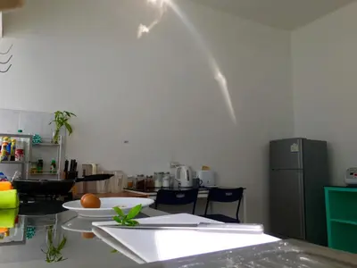 a kitchen with a counter and a table with chairs at Sense of Yanui in Nai Harn Beach