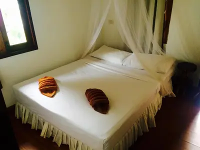 a bed with two croissants on top of it at Tropical Garden Bungalow in Phi Phi Don