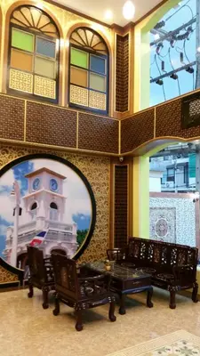 a room with three benches and a picture of a building at Phuket Chinoinn-SHAPlus Certified in Phuket Town