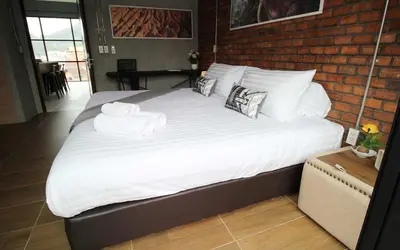 a large bed with two towels on top of it at Unique Loft Apartment in Kamala Beach