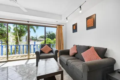 a living room with a couch and a table at The Club Residence Kamala Beach in Kamala Beach