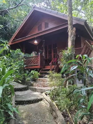 a small house with stairs leading to a porch at Sabai Corner Bungalows - SHA Extra Plus in Ko Yao Noi